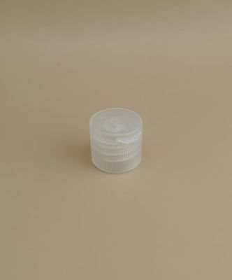 Kleine, doorzichtige, ronde, geribbelde plastic dop voor cosmeticaflessen