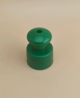Groene plastic gladde dop met knop voor cosmetische flessen